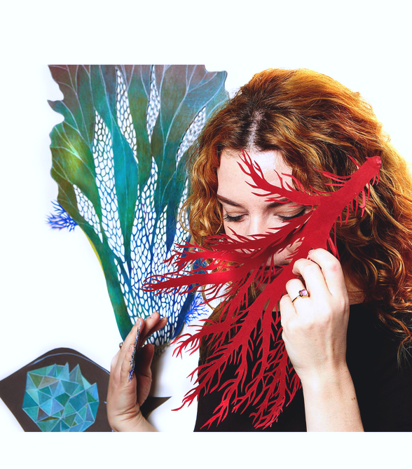 Anna Charaktinou with red and turquoise hand-cut paper works