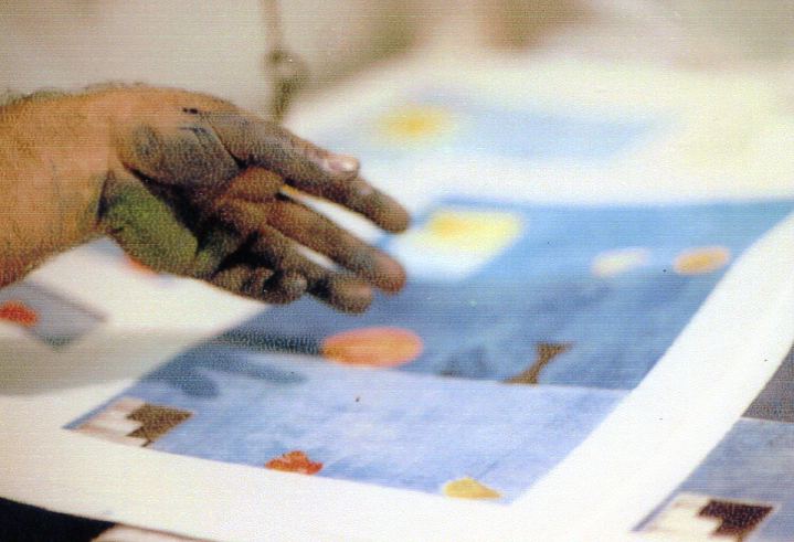 Close view of Otto Urwyler working on a blue monotype