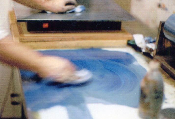 Otto Urwyler rolling ink across a printing surface